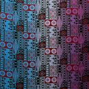 A flat-lay view of a Fijian Tapa Barkcloth fabric featuring a traditional geometric pattern. The design consists of repeating rectangular tiles in shades of blue, red, and purple, filled with intricate black tribal motifs including sunbursts, triangles, and linear hatches.