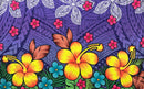 A flat-lay view of the Hibiscus, Plumeria Assortment Sarong (Style 3) featuring a vibrant Polynesian-inspired design. The pattern includes large yellow and orange hibiscus flowers as the central focus, surrounded by smaller pink and blue blossoms. The background is a deep purple with layered traditional tribal motifs, including white geometric patterns, grey stylized leaf designs, and intricate black line work throughout the fabric.