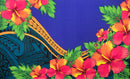 A flat-lay view of the Hibiscus, Plumeria Assortment Sarong (Style 9) featuring a vibrant Polynesian-inspired design. The pattern includes large, bright red and orange hibiscus flowers as the focal point, set against a solid royal blue background. The design is accented with traditional black and blue Polynesian tribal motifs, including geometric patterns and stylized ocean waves, along with lush green leaves and smaller yellow plumeria blossoms.