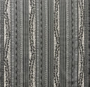 A fabric with a traditional Polynesian tattoo design, featuring black and white patterns.